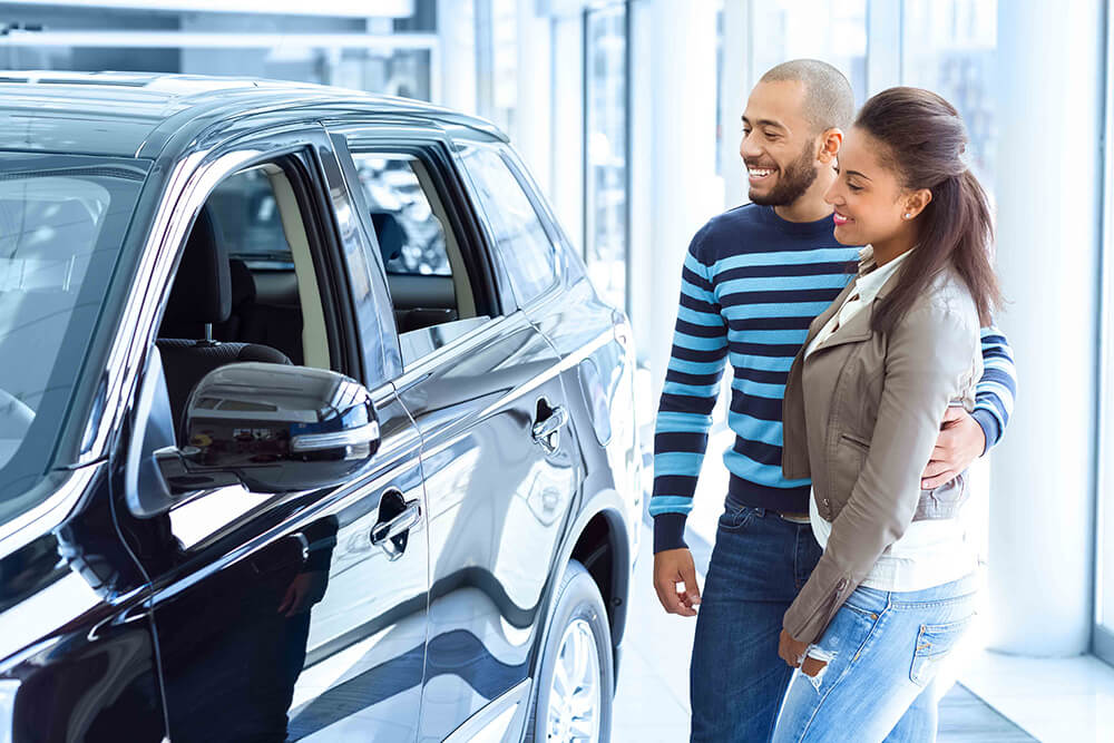 couple looking at a car